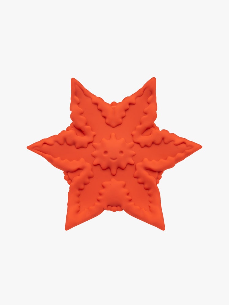 Cute Little F*ckers Starsi orange star shaped vibrator on light gray background