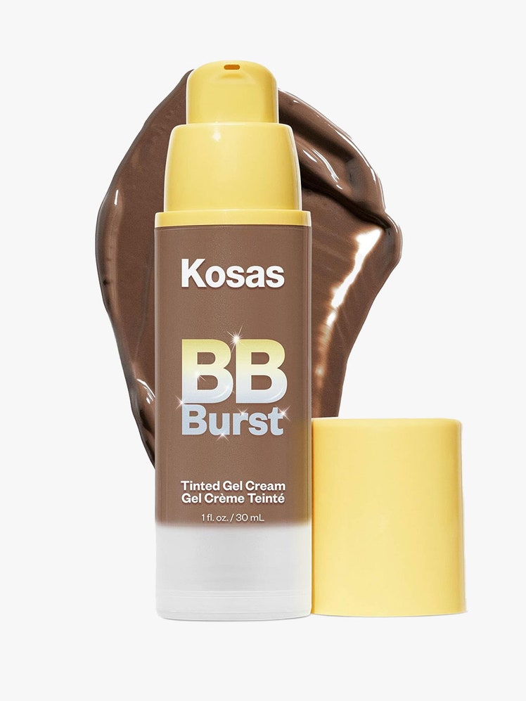 An open pump bottle of Kosas BB Burst in a dark sade
