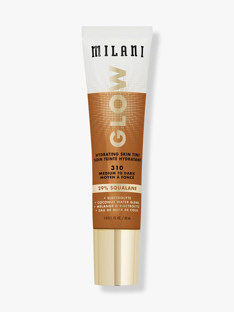 Milani Glow Hydrating Skin Tint white and medium/deep skin tone tube with gold cap on light gray background