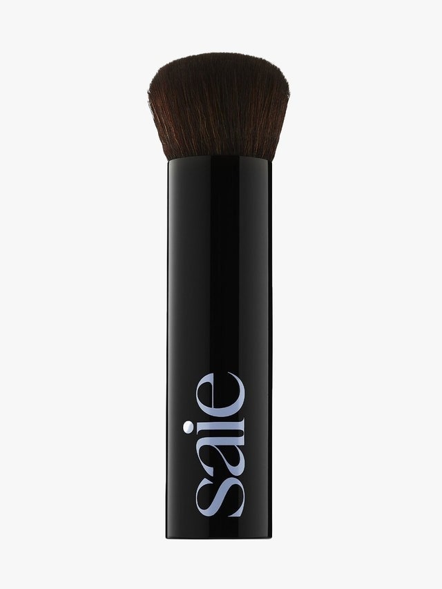 The Saie The Base Foundation Brush on a light gray background