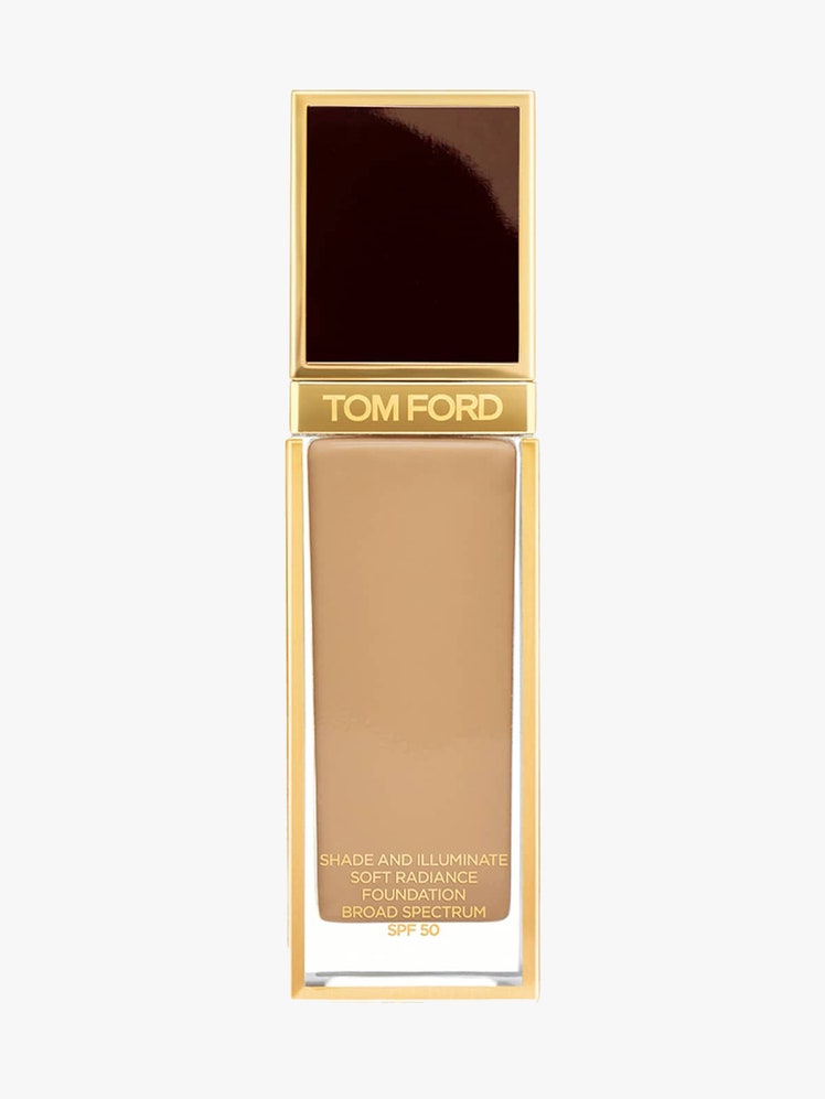 Tom Ford Shade and Illuminate Soft Radiance Foundation SPF 50 transparent, gold, and brown rectangle bottle of foundation on light gray background