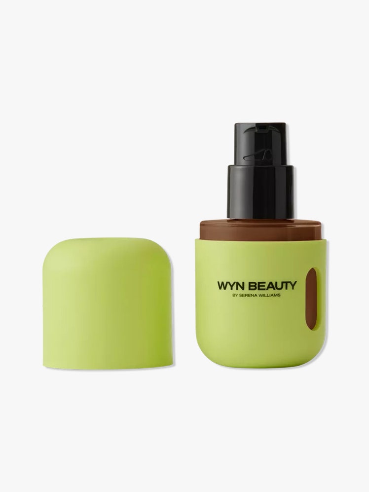 WYN Beauty Hydrating Skin Enhancing Tint green bottle of skin tint with black pump and cap to the side on light gray background