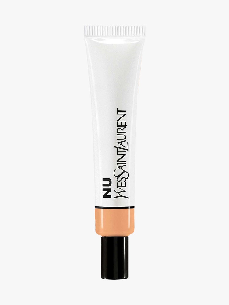 YSL Beauty Nu Bare Look Hydrating Skin Tint white tube with transparent window and black cap on light gray background