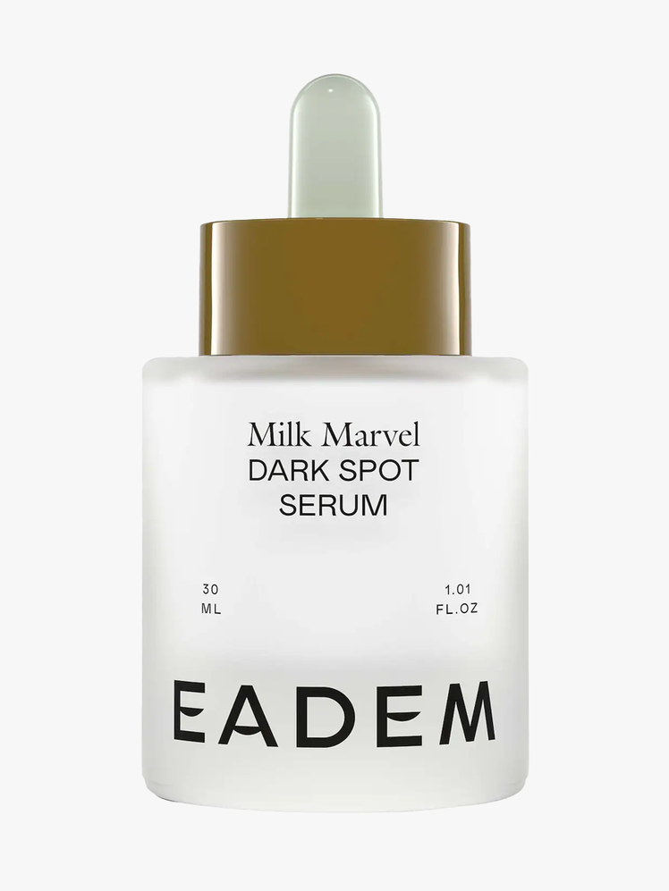 Eadem Milk Marvel Dark Spot Serum in frosted clear bottle with beige and white pipette on light gray background