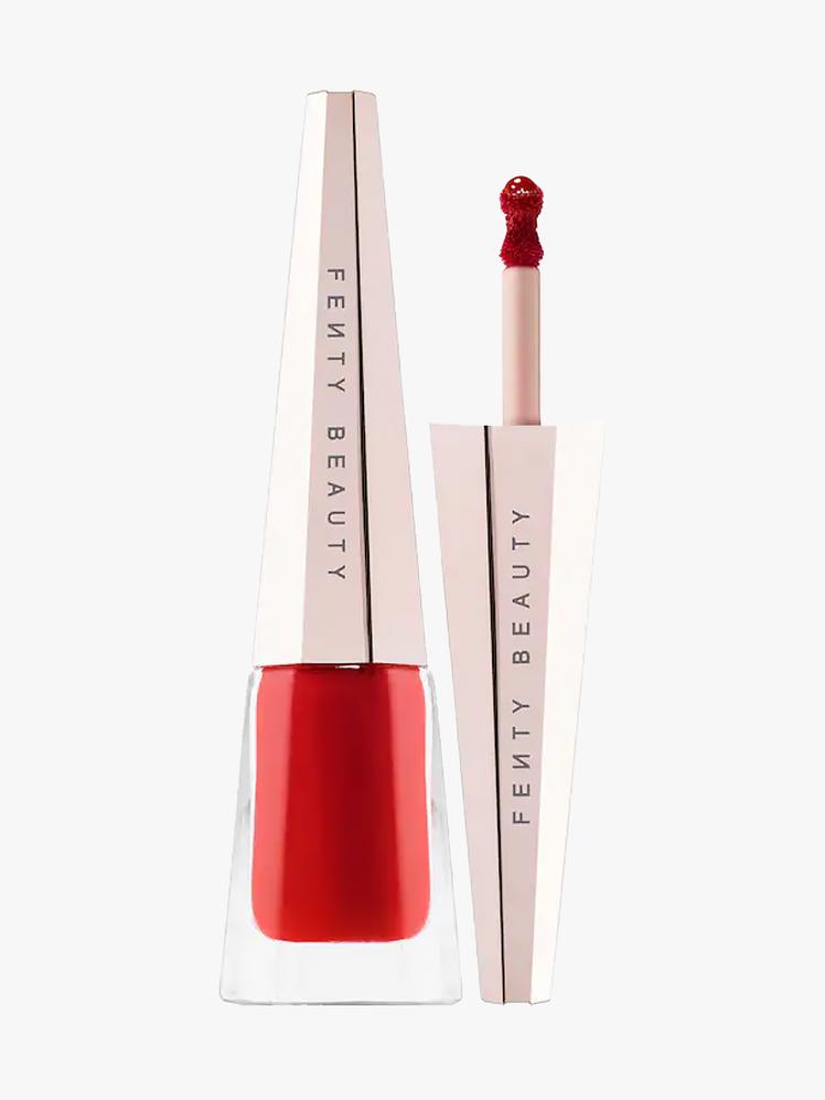 Fenty Beauty Stunna Lip Paint twist up component in red with branded cap on a light gray background