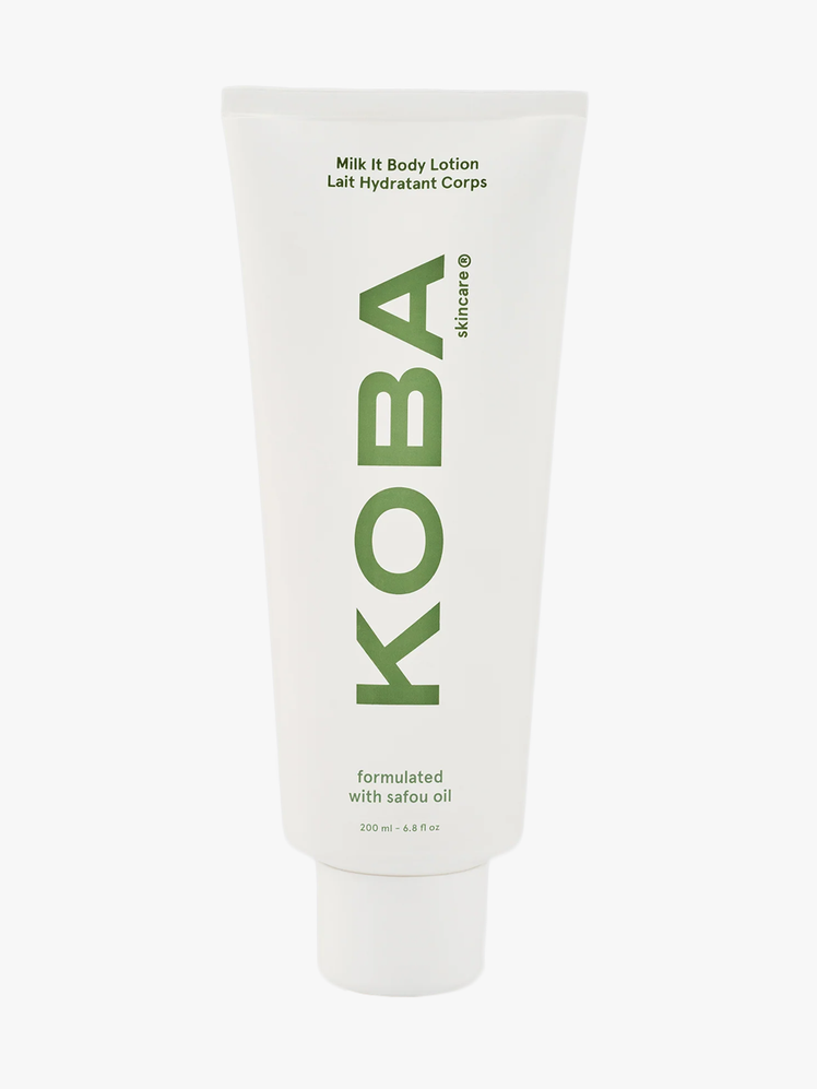 Koba The Milk It Body Lotion in white branded tube on light gray background