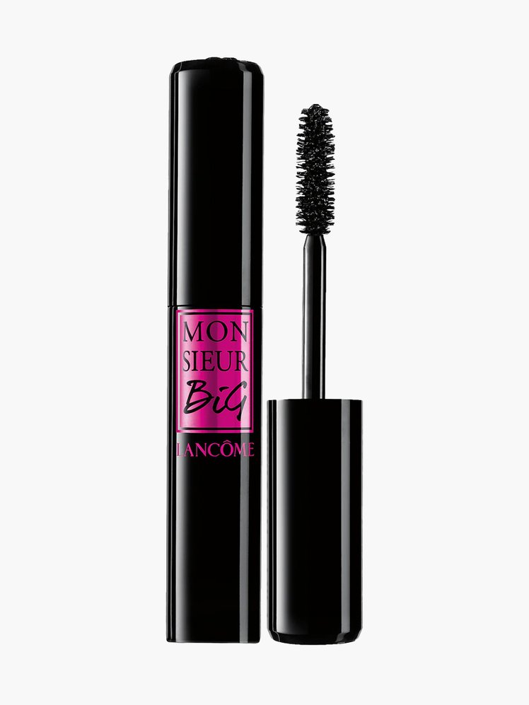 Monsieur Big Volumizing Mascara in branded black and pink tube next to black brush applicator on light gray background